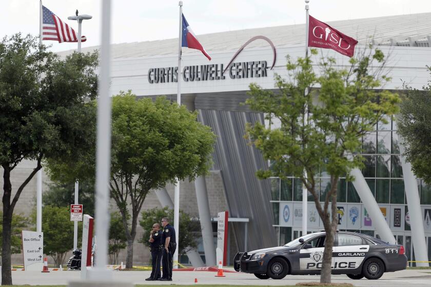 Police stand guard outside the Curtis Culwell Center on Monday in Garland, Texas. Two men who were roommated opened fire on police Sunday night who were guarding a provocative contest for Prophet Muhammed cartoons. A police officer returned fire killing both men.