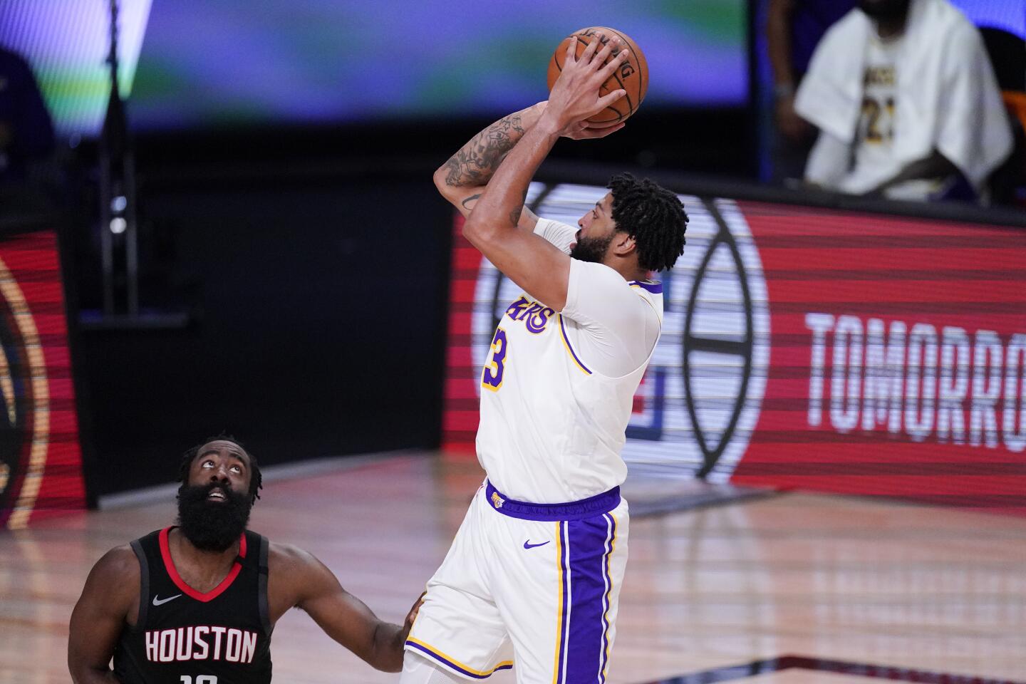 The Lakers' Anthony Davis shoots over the Rockets' James Harden in the first half of Game 5 on Saturday near Orlando, Fla.