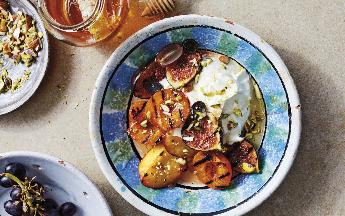 Grilled stone fruit is accented with cold yogurt, pistachios and honey in this Mediterranean breakfast.