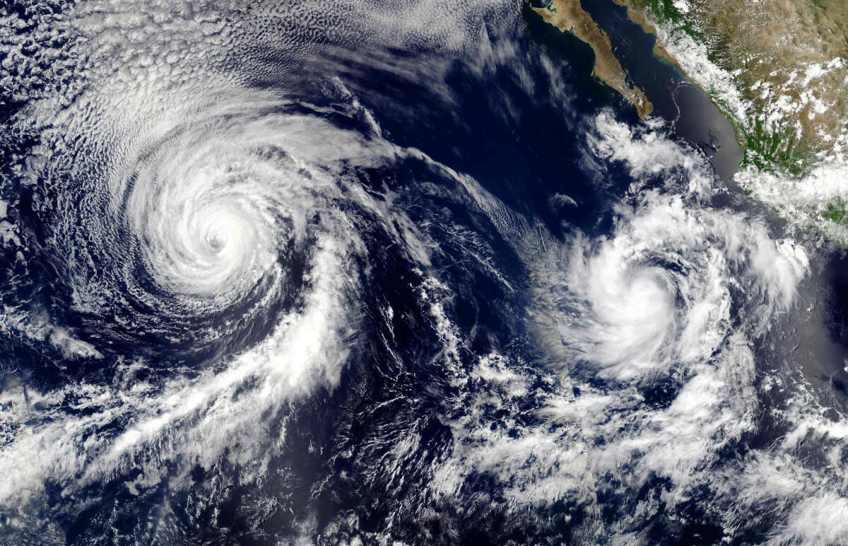 This NASA satellite image from July 12 shows Hurricane Celia on the left and Tropical Storm Darby churning in the Pacific Ocean.