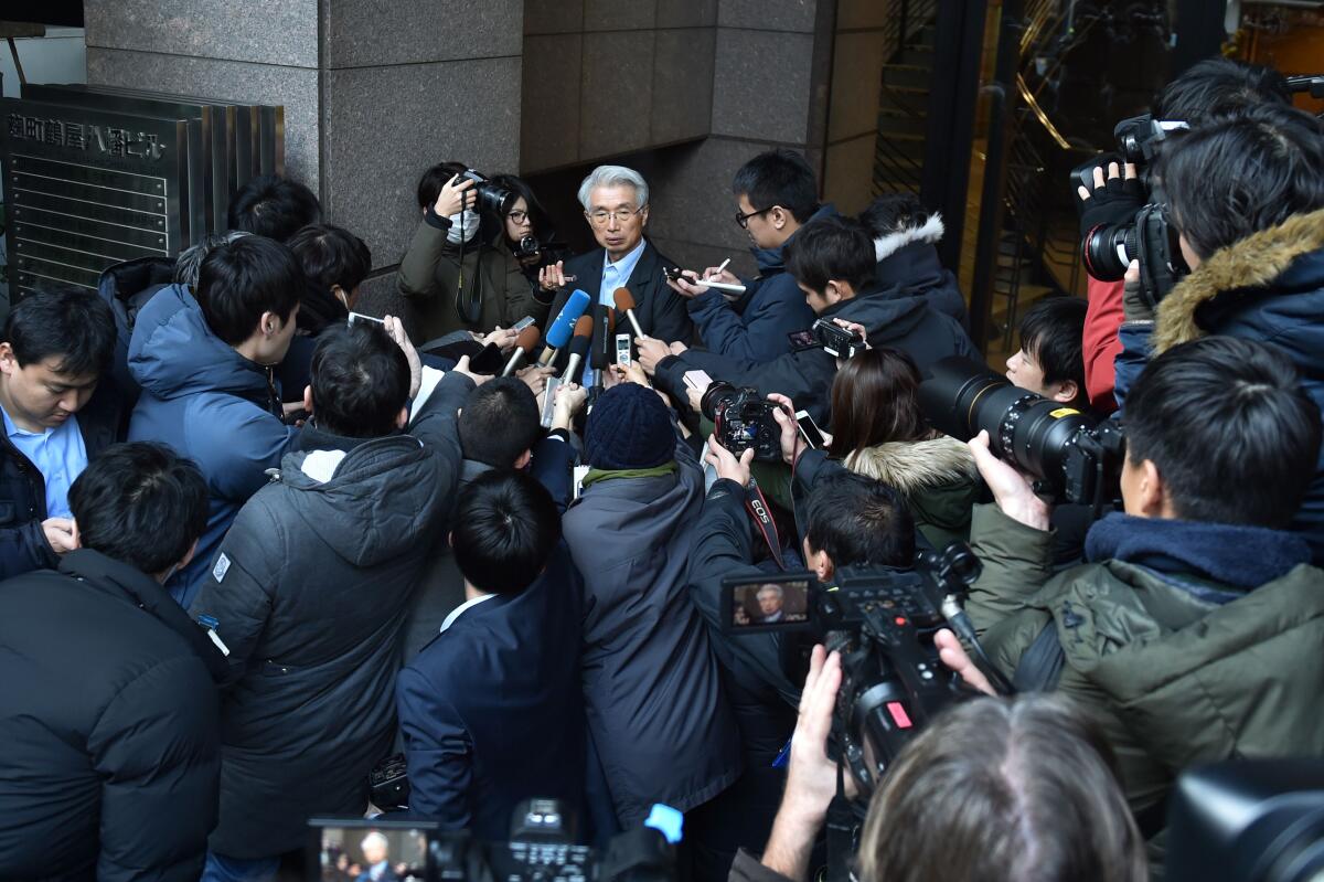 Junichiro Hironaka, the lawyer for former Nissan chairman Carlos Ghosn, fields media questions outside his office in Tokyo.