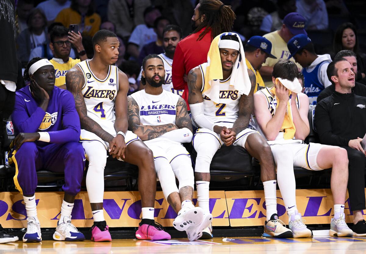 Lakers players sit on the bench late in the fourth quarter during a loss to the Denver Nuggets.