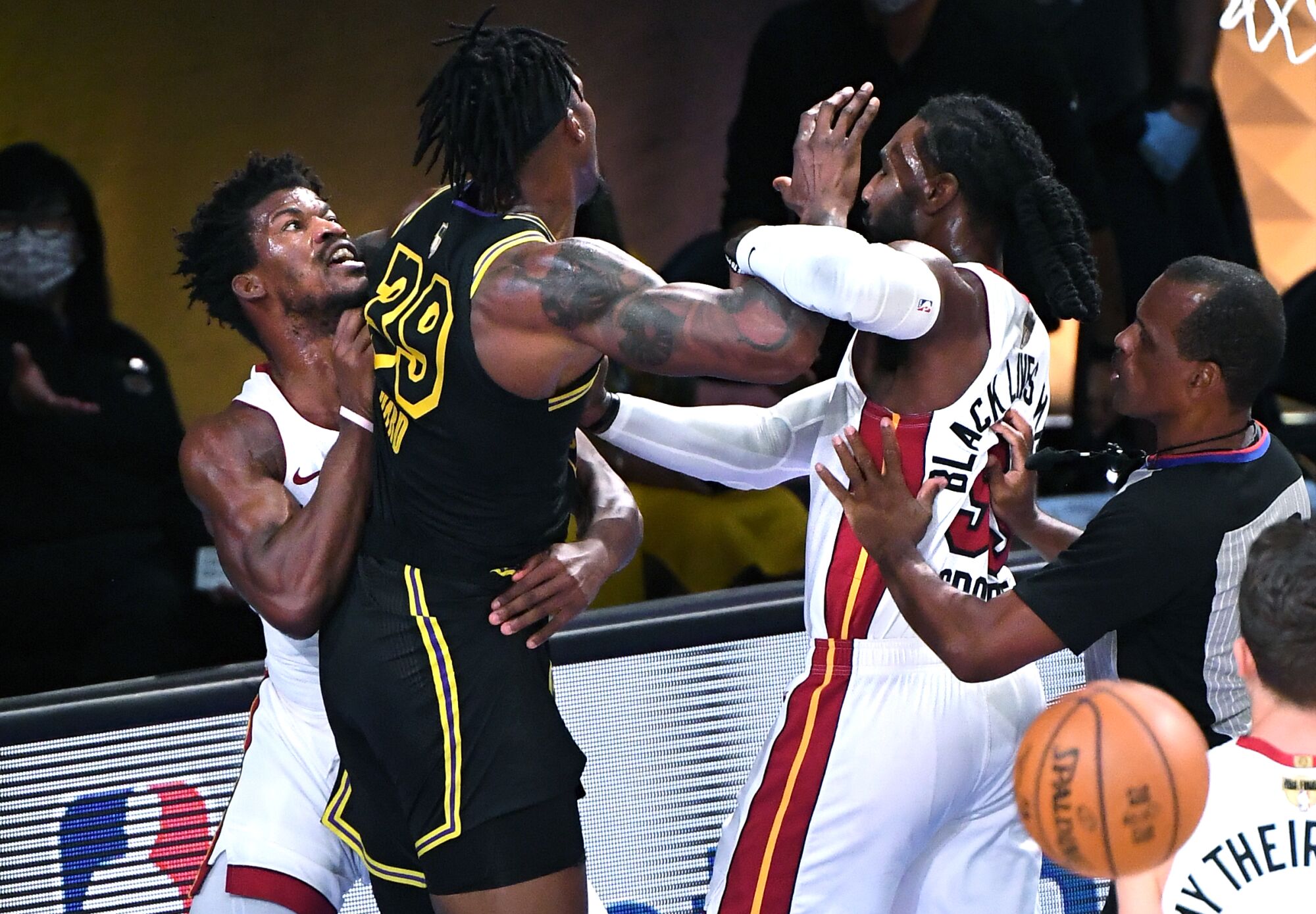 Lakers center Dwight Howard is held back by Heat forward Jimmy Butler while getting into a confrontation with Jae Crowder.