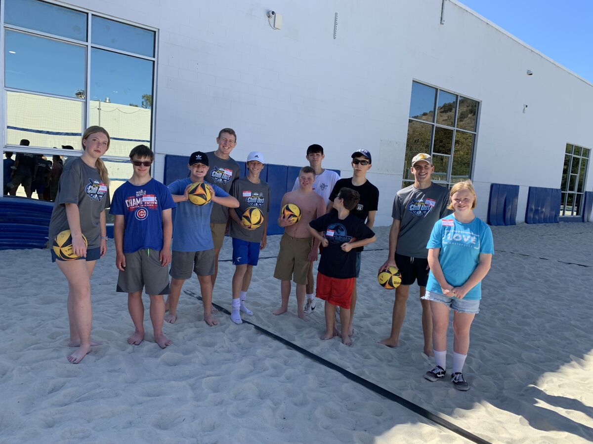 Coaches and San Diego Chill Out participants play beach volleyball.
