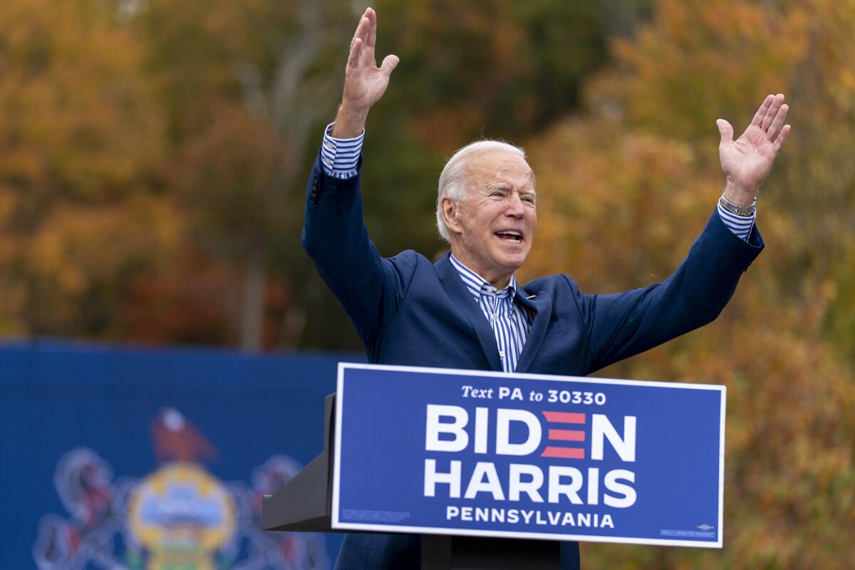FILE - Democratic presidential candidate former Vice President Joe Biden speaks at a drive-in campaign stop at Bucks County Community College in Bristol, Pa., Oct. 24, 2020. Biden and his allies hope big recent wins on climate, health care and more will at least temporarily tamp down questions among top Democrats about whether he will run for reelection. (AP Photo/Andrew Harnik, File)