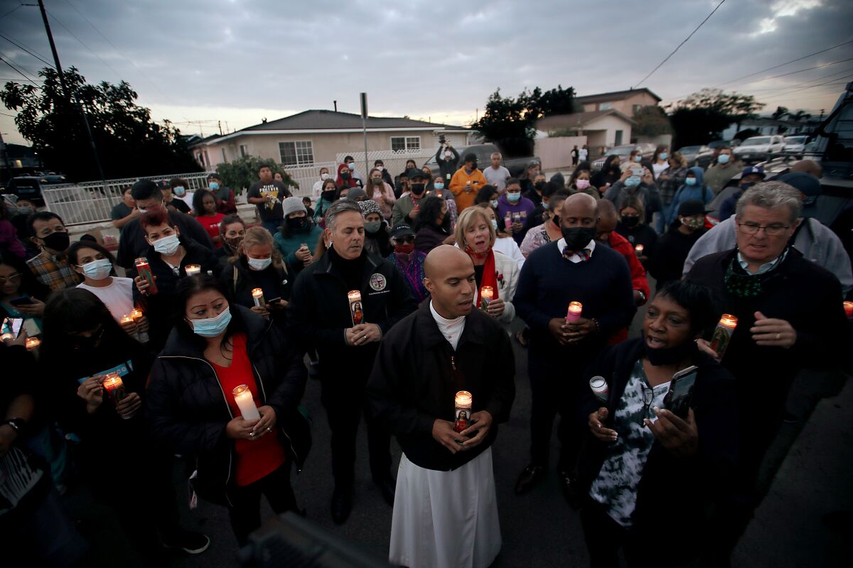Wilmington residents hold a candlelight vigil for three people who were shot near Wilmington Park Elementary School