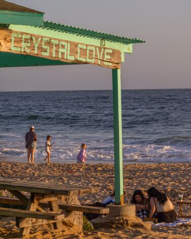 Newport Beach, CA - June 22: Beach goers enjoy nice weather at sunset at Crystal Cove State Beach in Newport Beach Saturday, June 22, 2024. (Allen J. Schaben / Los Angeles Times)