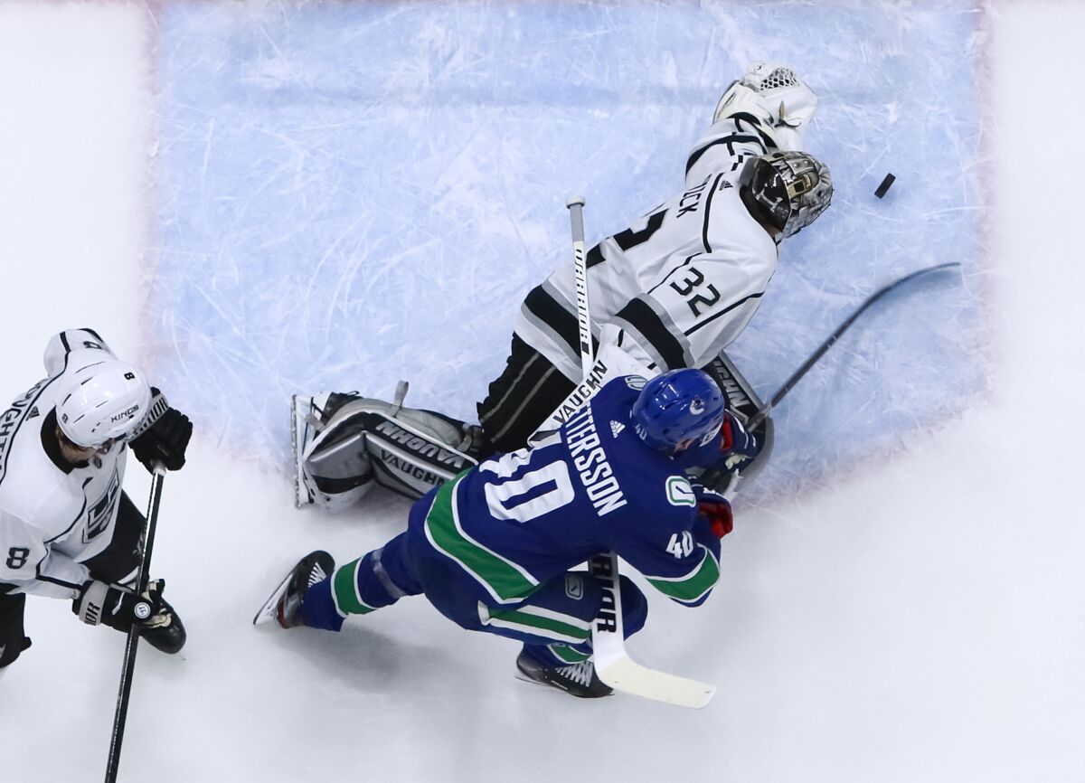 Kings goalie Jonathan Quick makes a save against Vancouver forward Elias Pettersson during an 8-2 loss to the Canucks on Wednesday.