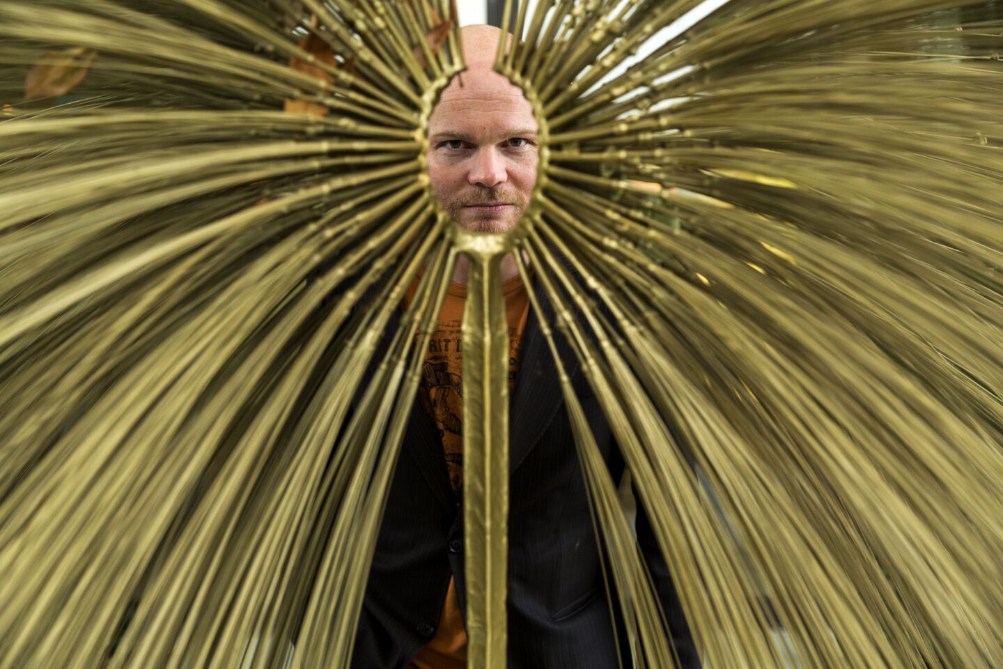 Director Grimur Hakonardson peers through a sculpture during a tour of the the estate of Walter and Leonore Annenberg at Sunnyland Center & Gardens in Rancho Mirage.