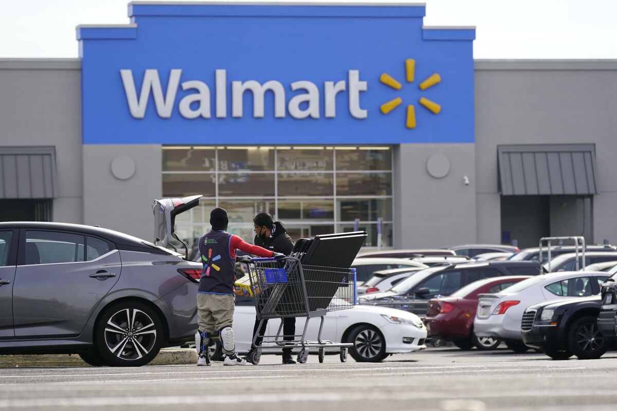 Shown is a Walmart location in Philadelphia, Wednesday, Nov. 17, 2021. Walmart is reporting strong fiscal fourth-quarter results that exceeded analysts' expectations as the nation's largest retailer defies higher inflation and supply chain issues. Walmart said Thursday, Feb. 17, 2022, that net income was $3.56 billion, or $1.28 per share in the quarter ended Jan. 31. That compares with a loss of $2.91 billion, or loss of 74 cents. Revenue was $151.5 billion.(AP Photo/Matt Rourke)