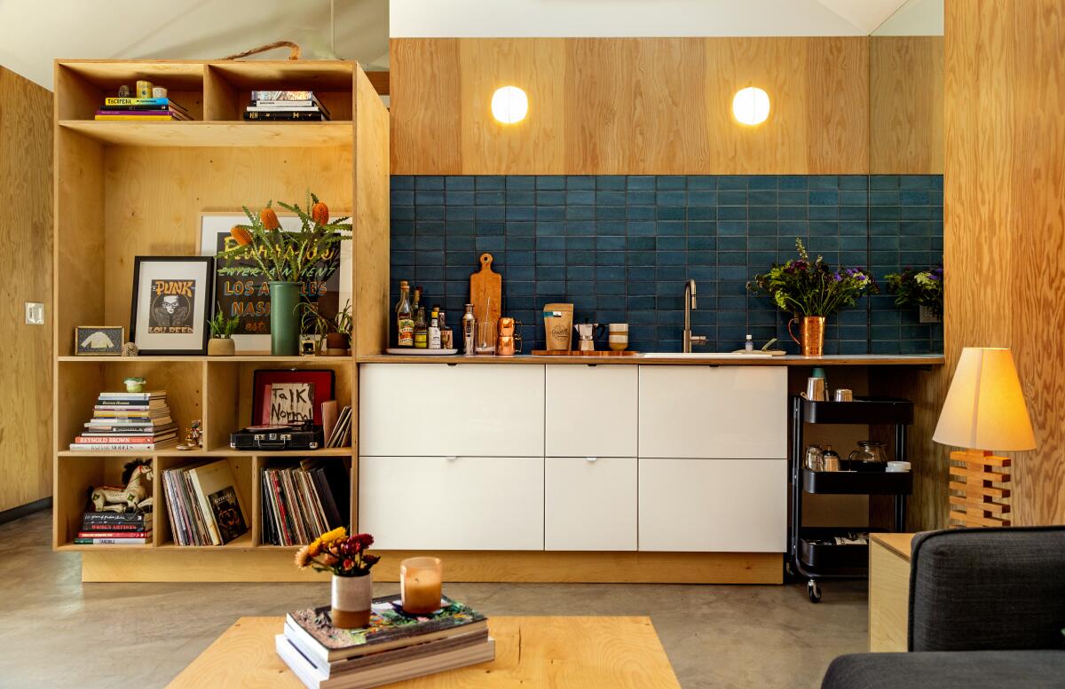 An interior with warm wood walls and storage units