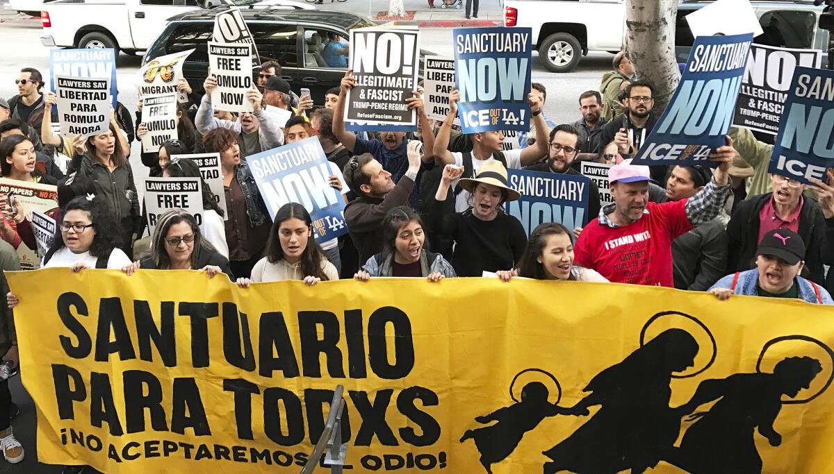 Some of about 100 people demonstrate outside a federal immigration court in Los Angeles on Monday, March 6, 2017. (Michael Balsamo / AP)