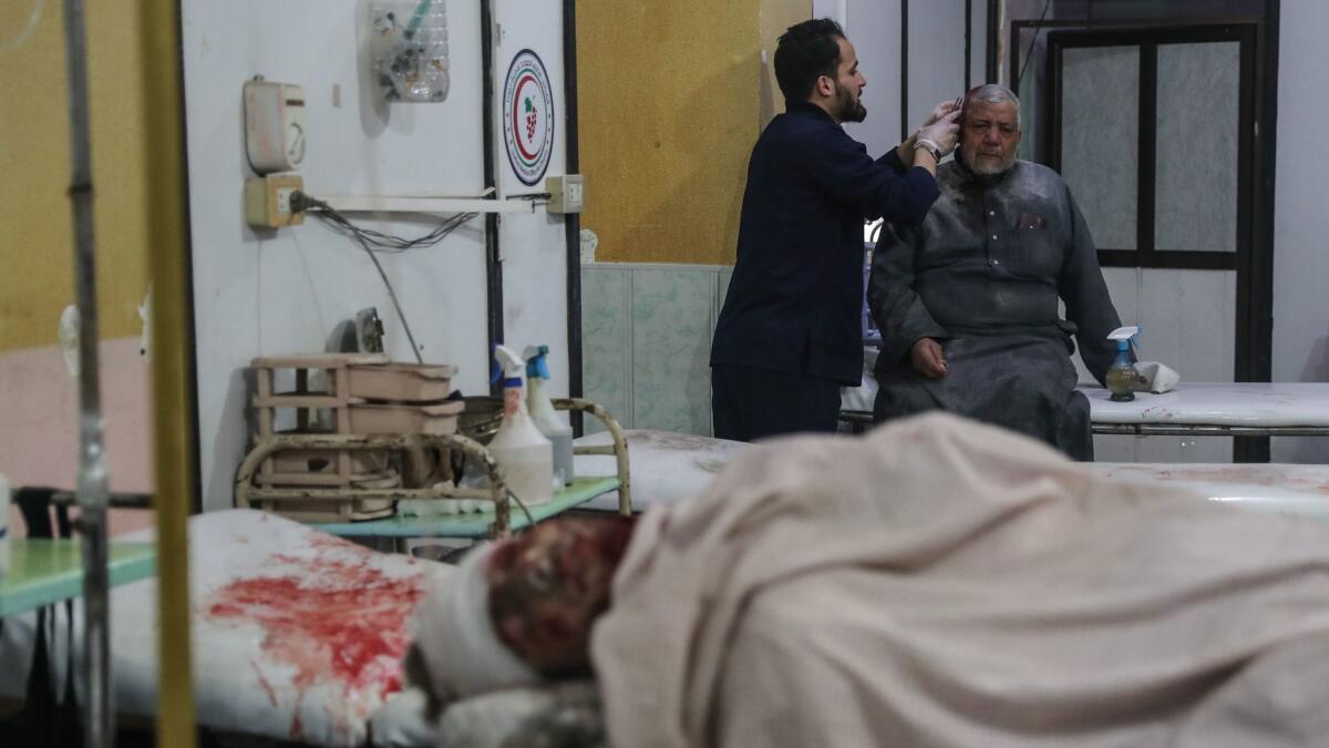 Injured people receive treatment at a hospital after airstrikes hit the city of Mesraba in Eastern Ghouta, Syria, on Jan. 3.