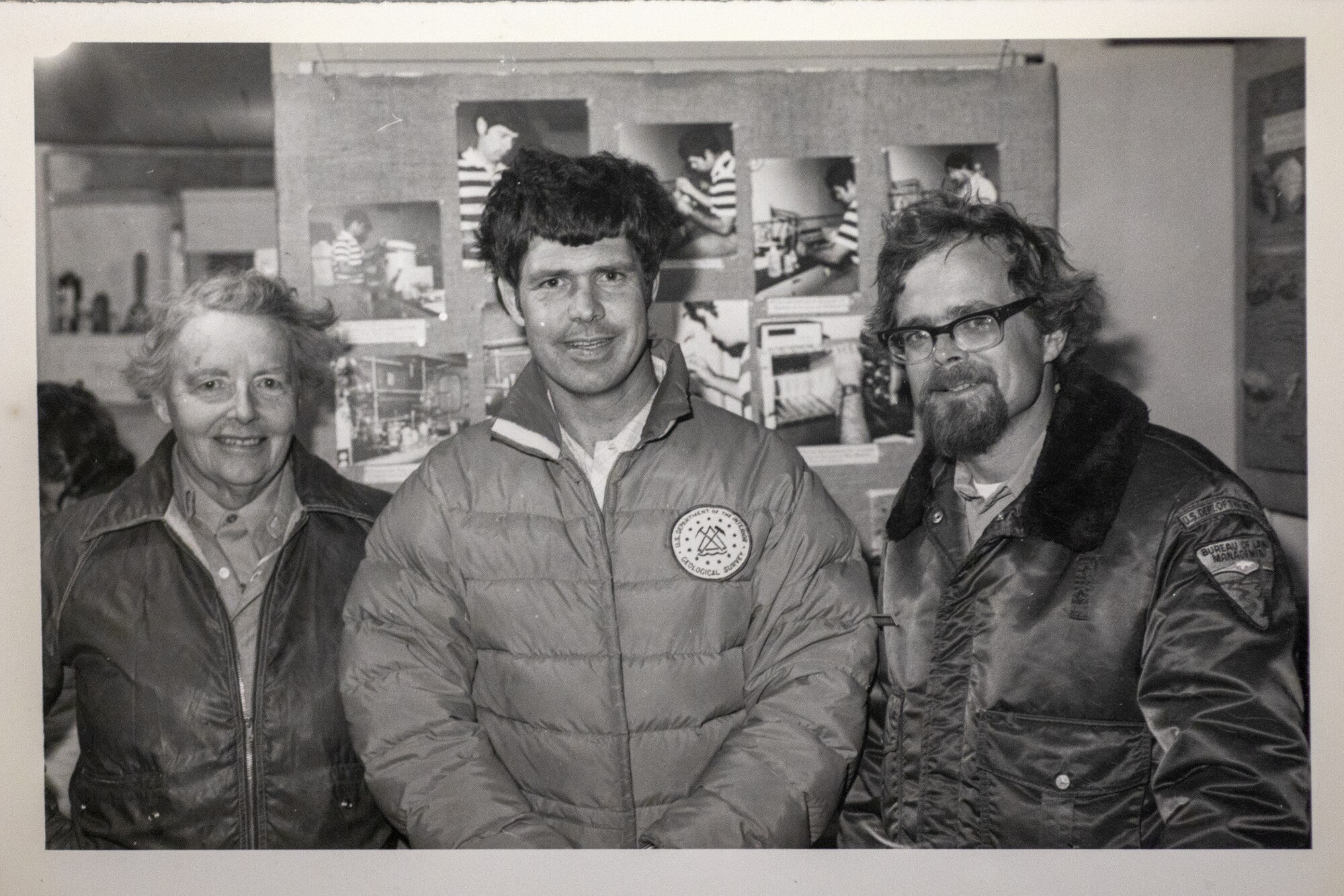 A woman and two men inside a field office
