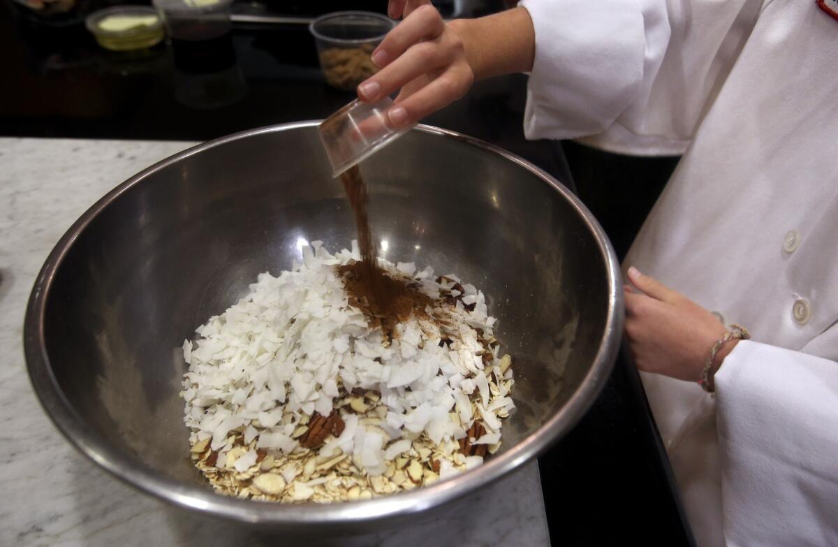 Combine oats, wheat bran, pecans, almonds and coconut in a large bowl. Then stir in cinnamon, nutmeg and brown sugar.