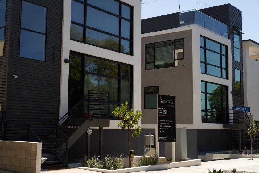 LOS ANGELES, CA - SEPTEMBER 22: A 'for sale' sign is displayed in front of a new townhouse style home on September 22, 2022 in Los Angeles, California. The U.S. housing market is seeing a slow down in home sales due to the Federal Reserve raising mortgage interest rates to help fight inflation. (Photo by Allison Dinner/Getty Images)