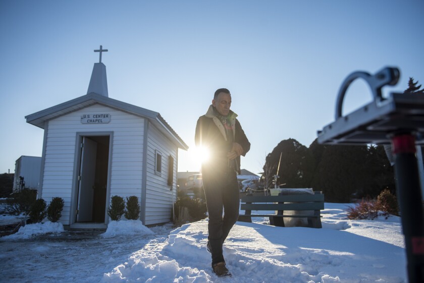 Bruce Springsteen walking in the snow outside a small church in a Super Bowl commercial for Jeep