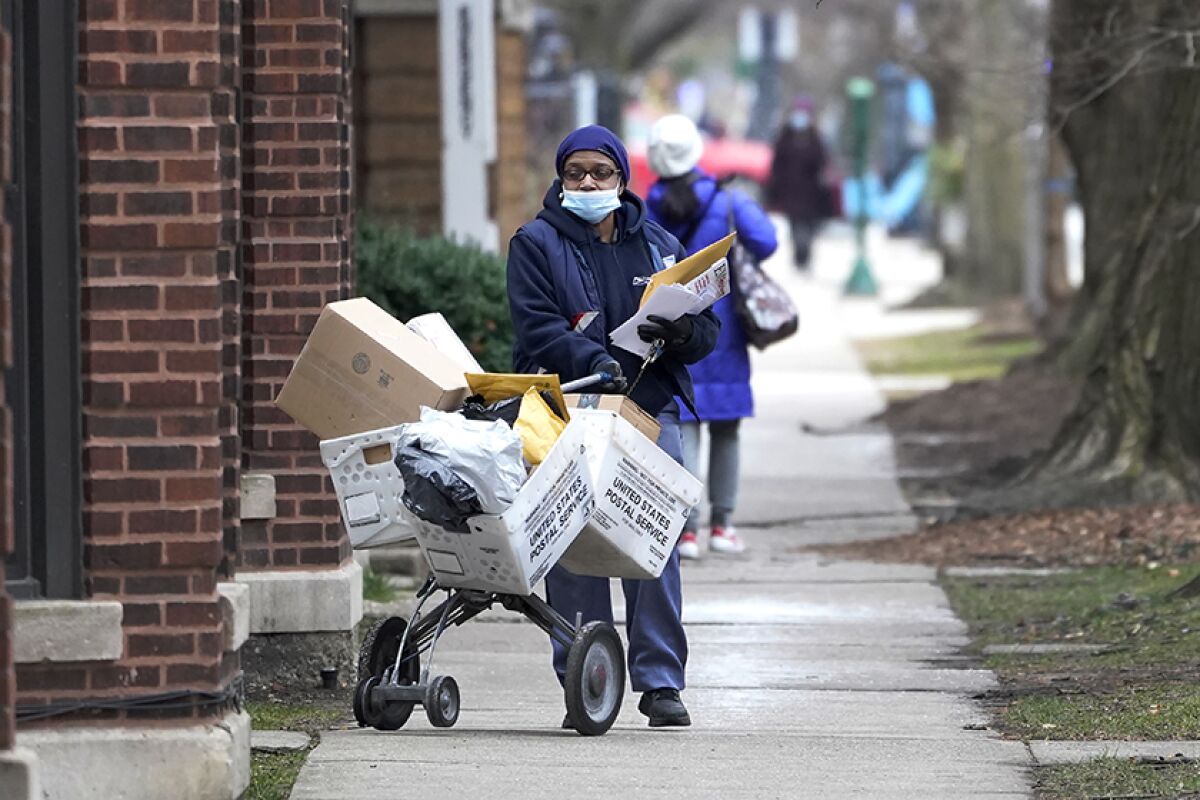 A U.S. postal worker makes deliveries in the Hyde Park neighborhood of Chicago.