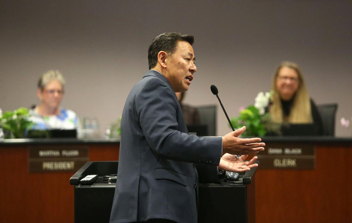Russell Lee-Sung addresses Newport-Mesa Unified trustees on coronavirus protocols in a 2020 meeting. He will retire Aug. 3.
