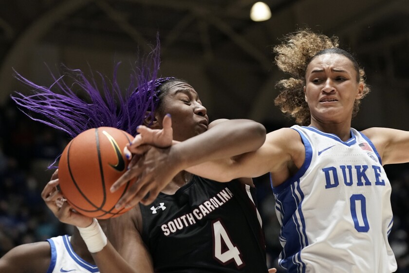South Carolina forward Aliyah Boston (4) grabs a rebound against Duke guard Celeste Taylor (0) during the first half of an NCAA college basketball game in Durham, N.C., Wednesday, Dec. 15, 2021. (AP Photo/Gerry Broome)