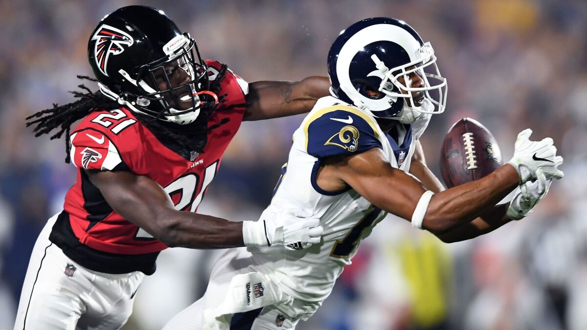 Rams receiver Robert Woods makes a catch in front of Atlanta cornerback Desmond Trufant during the NFC wild card game on Jan. 6.