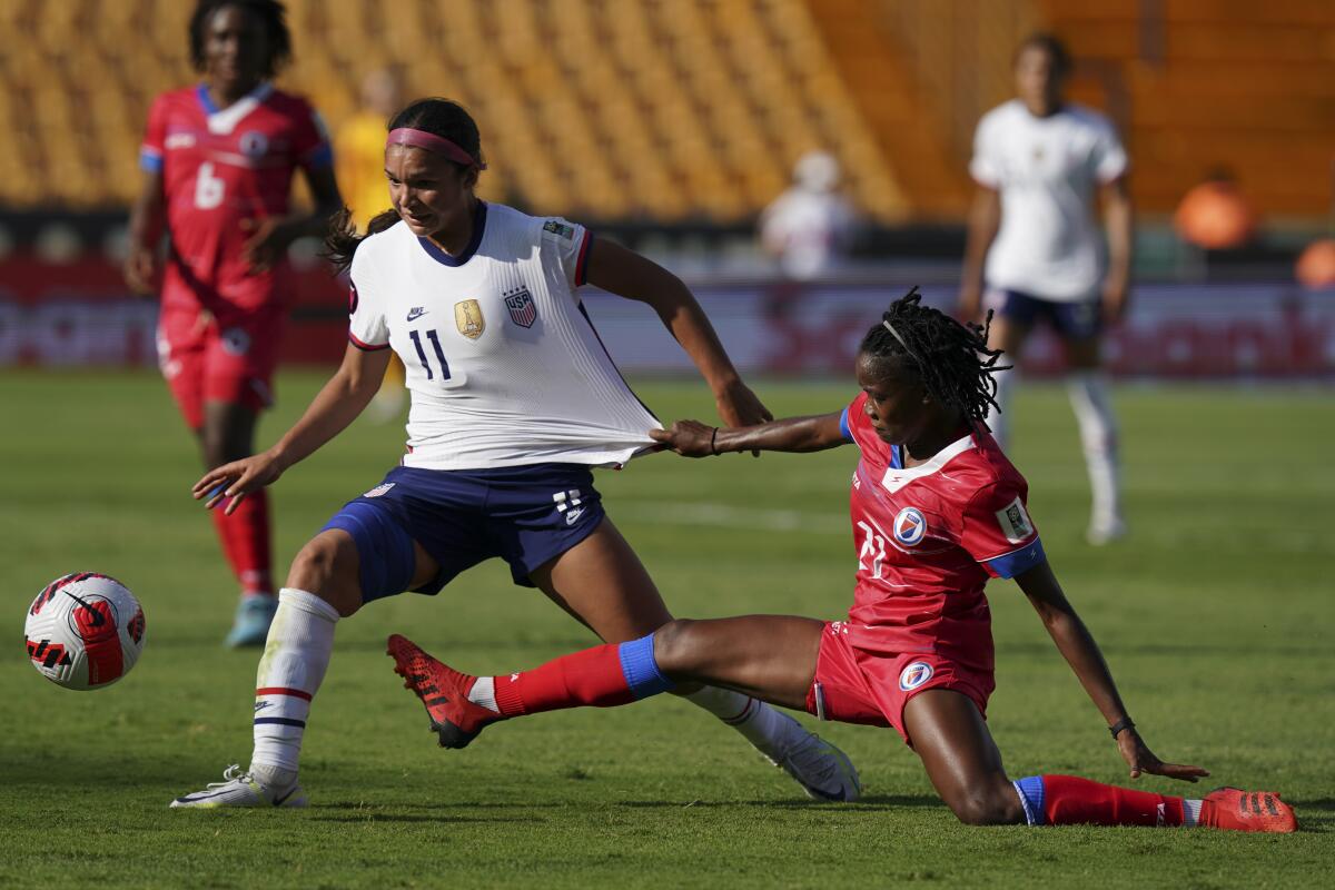 Sophia Smith, left, controls the ball in front of Haiti's Ruthny Mathurin.