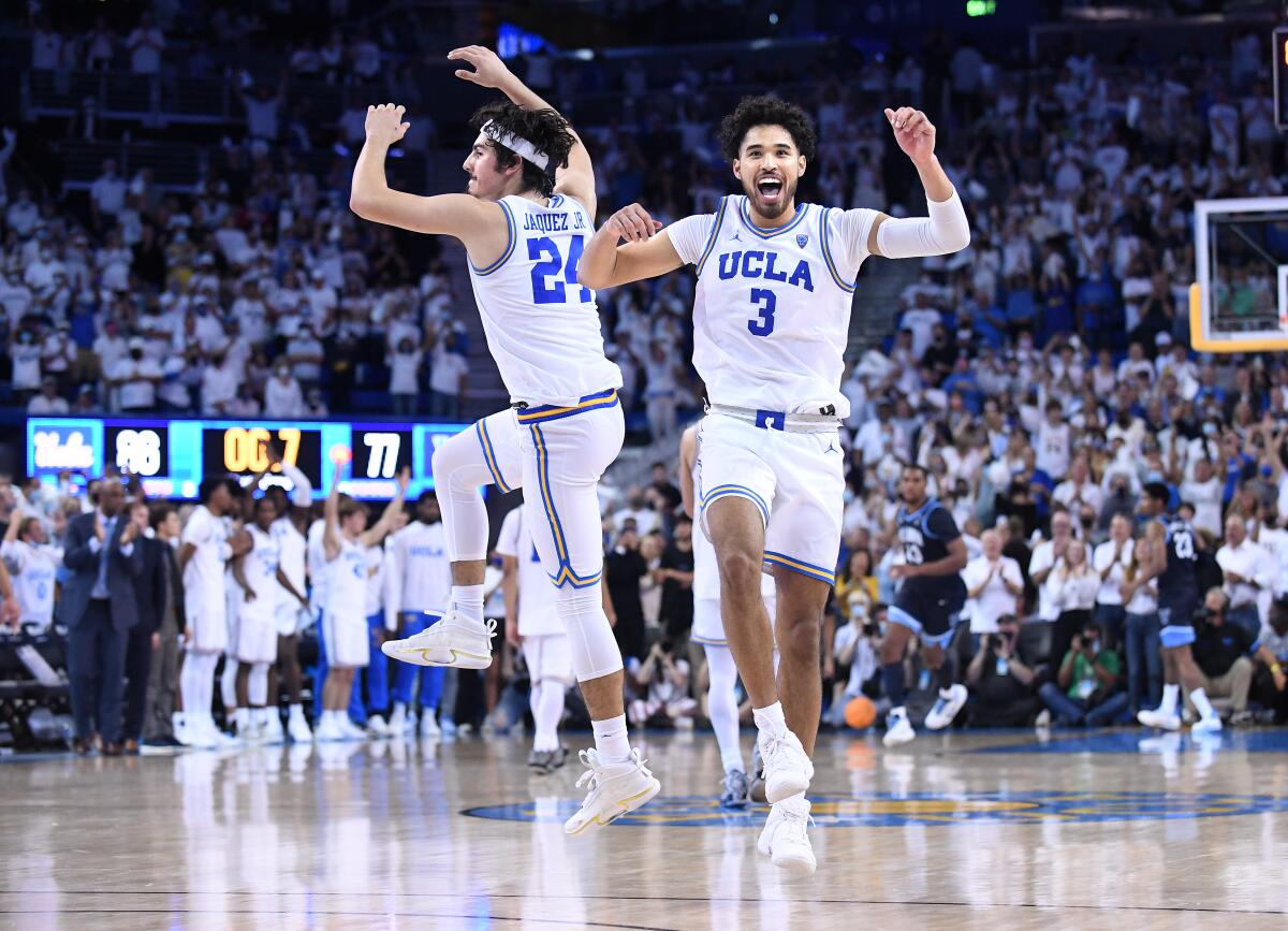 UCLA's Jaime Jaquez Jr., left, celebrates with Johnny Juzang in the final seconds of the Bruins' 86-77 win.