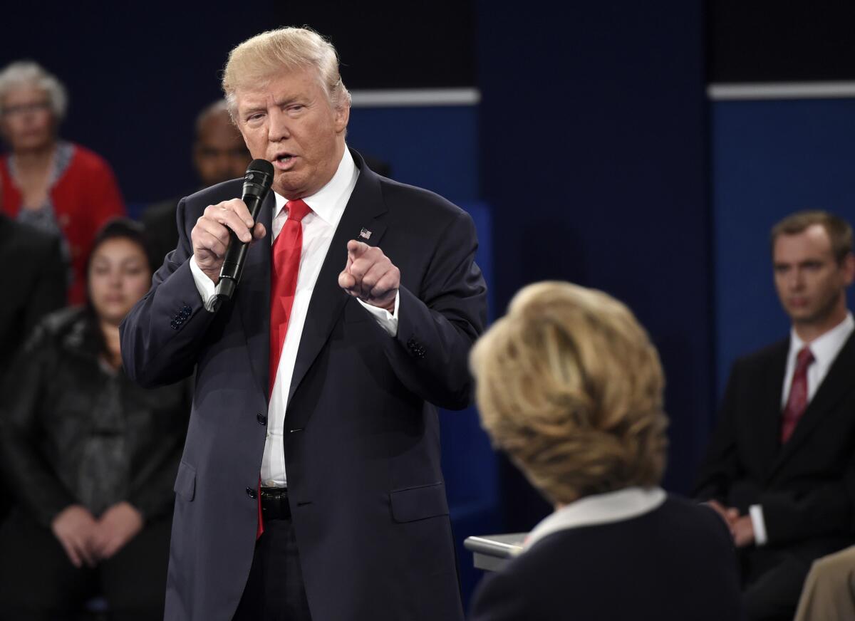 Republican presidential nominee Donald Trump points at Democratic nominee Hillary Clinton as he speaks during the second presidential debate at Washington University in St. Louis.