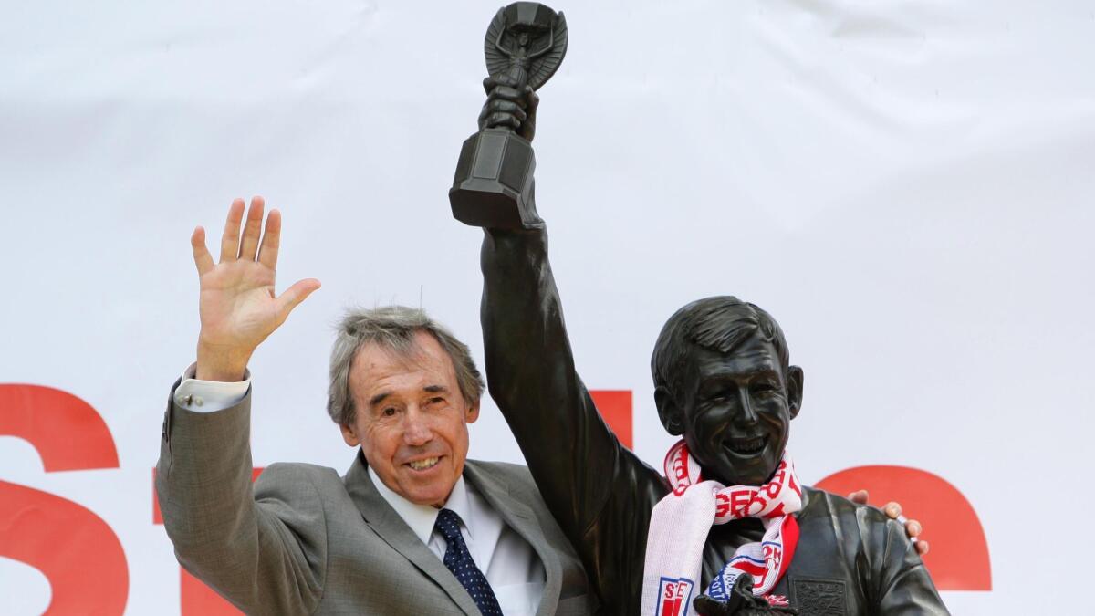 In this July 12, 2008 file photo, former England soccer goalkeeper Gordon Banks stands next to his statue at the Britannia Stadium in Stoke, England. Banks died Tuesday at 81.