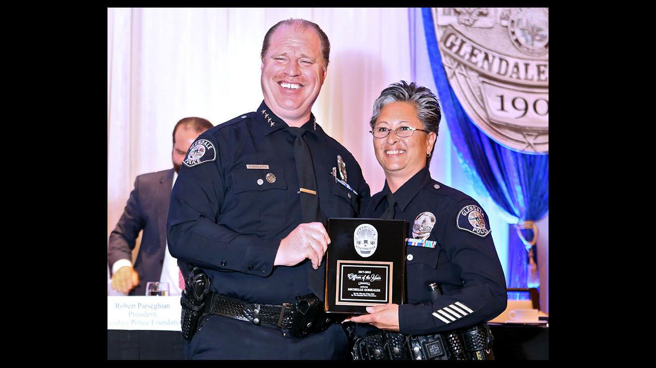 Glendale Police Chief Carl Povilaitis congratulates Officer of the Year recipient officer Michelle Gonzalez, at the 23rd Annual Glendale Police Awards Luncheon, at the Glendale Hilton on Thursday, May 10, 2018.