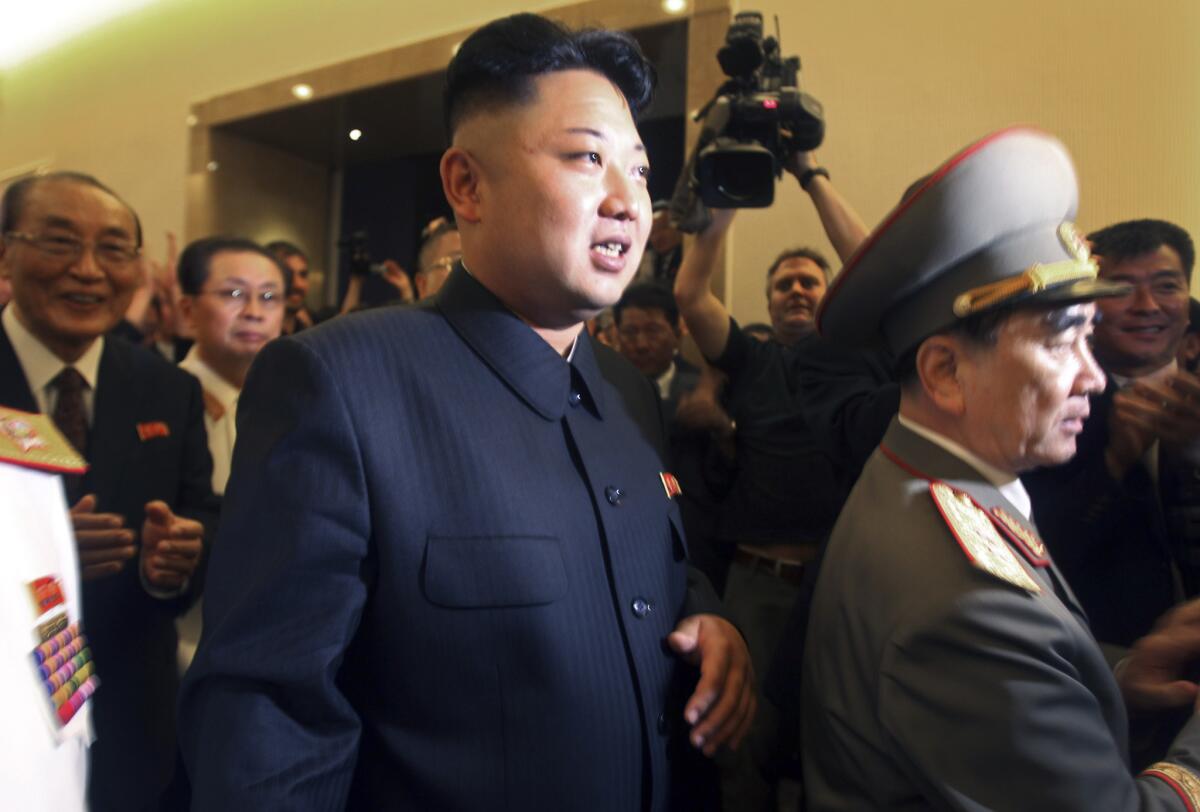 North Korean leader Kim Jong Un, center, is followed by his uncle Jang Song Thaek, second from left, as he tours a museum last summer in Pyongyang, the capital.