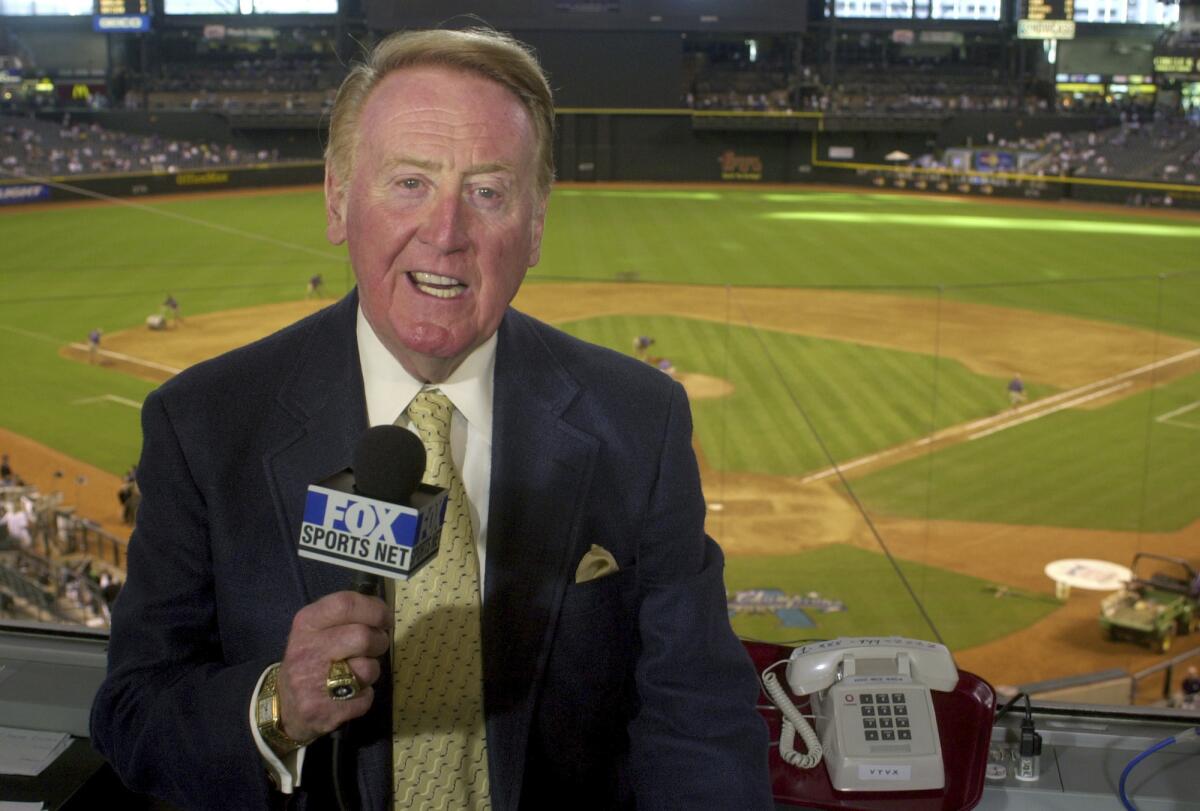 Los Angeles Dodgers television play-by-play announcer Vin Scully rehearses before a baseball game 