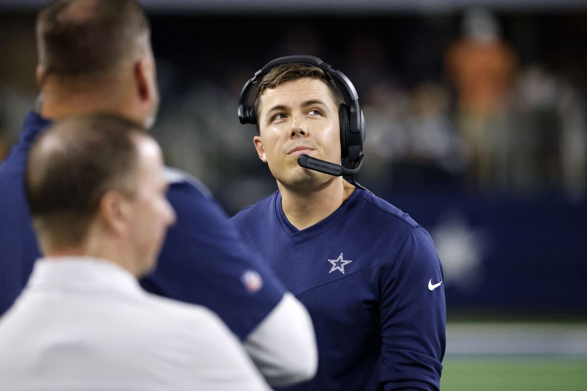 FILE - Dallas Cowboys offensive coordinator Kellen Moore walks along the sideline in the first half of a preseason NFL football game against the Seattle Seahawks in Arlington, Texas, Aug. 26, 2022. The Los Angeles Chargers agreed to terms with Kellen Moore to become offensive coordinator on Monday, Jan. 30, 2023. (AP Photo/Ron Jenkins)