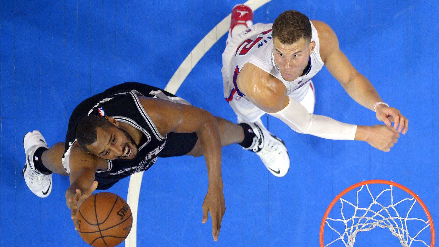 San Antonio Spurs center Boris Diaw, left, shoots over Clippers forward Blake Griffin during the first half of Game 7 of the Western Conference quarterfinals at Staples Center on May 2, 2015.