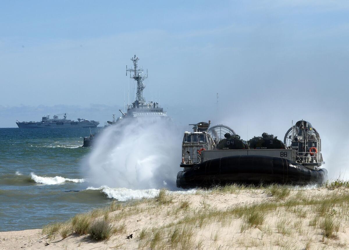 NATO troops make an amphibious landing off the coast of Ustka, northern Poland, during military exercises in mid-June. The multinational exercises aimed to demonstrate alliance capability to defend the Baltic region.