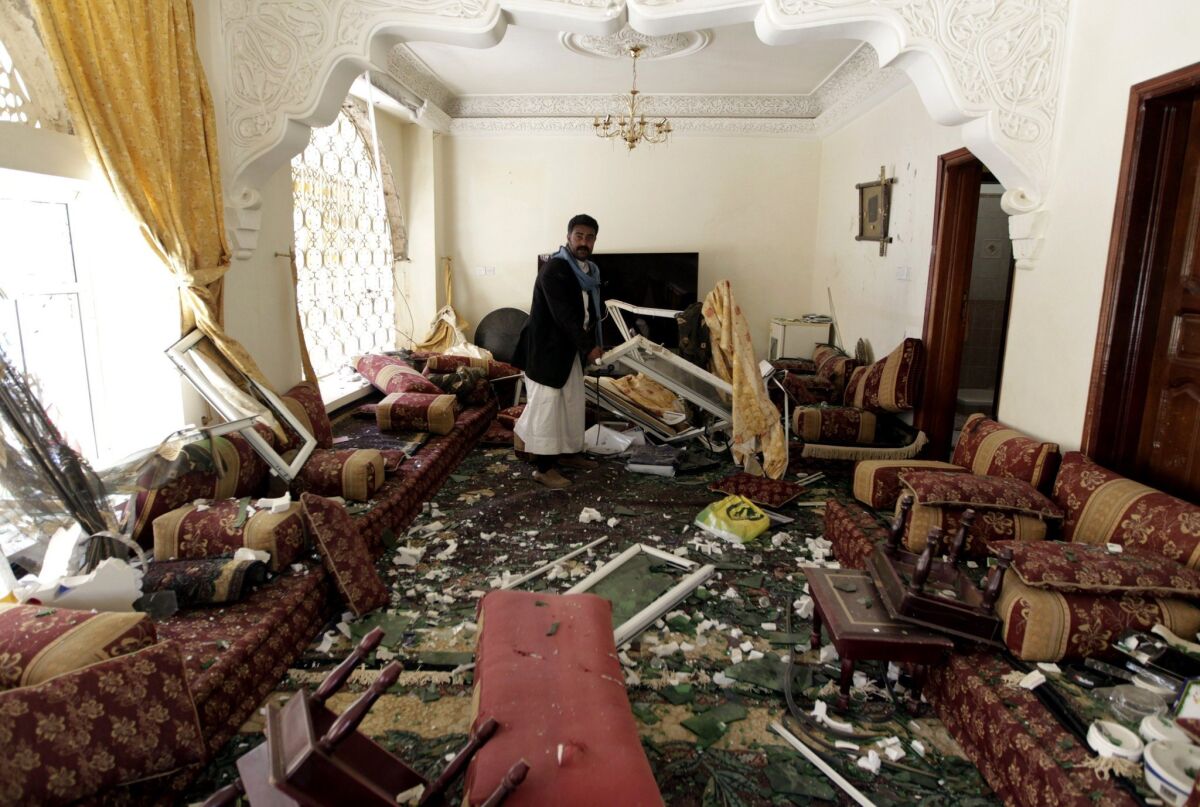 A Yemeni checks the damage at a house after a raid by Saudi-led coalition warplanes on a missile depot in the rebel-held part of Sana, the capital, on April 20.