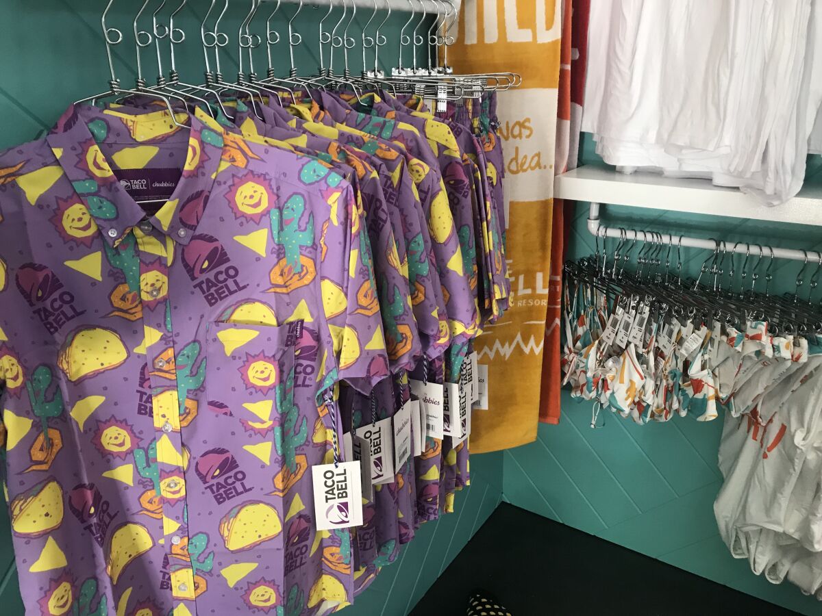 Taco Bell-themed shirts and other merchandise is for sale in the gift shop.