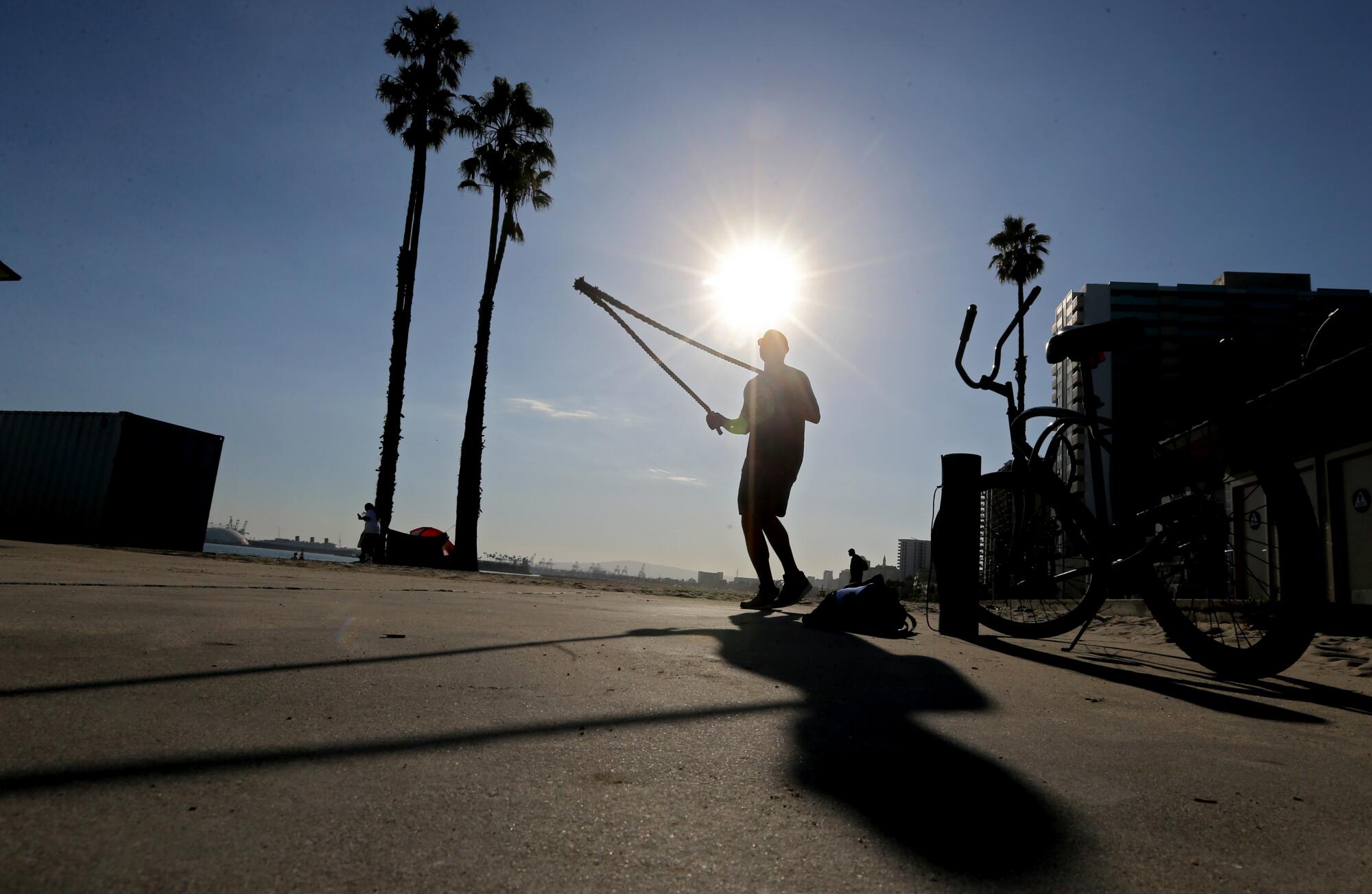 Nate Dozier exercises under a toasting sun in Long Beach.