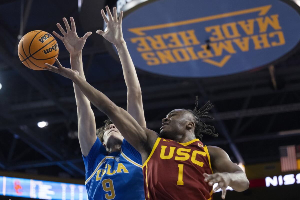 USC guard Isaiah Collier, right, shoots in front of UCLA forward Berke Buyuktuncel during the first half.