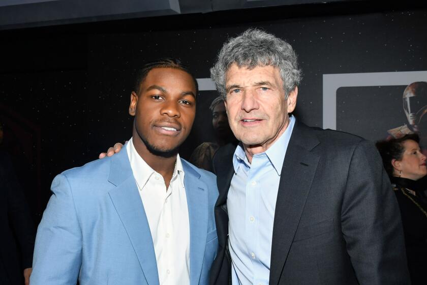 HOLLYWOOD, CALIFORNIA - DECEMBER 16: (L-R) John Boyega and Co-Chairman and Chief Creative Officer of The Walt Disney Studios Alan Horn arrive for the World Premiere of "Star Wars: The Rise of Skywalker", the highly anticipated conclusion of the Skywalker saga on December 16, 2019 in Hollywood, California. (Photo by Amy Sussman/Getty Images for Disney)