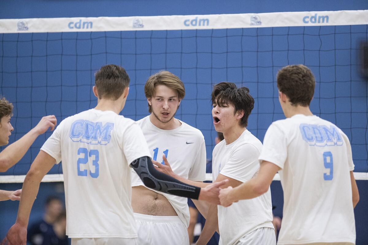 Corona del Mar's Shane Premer, left, Glen Linden, Bryce Dvorak and Nato Dickinson celebrate a point during a nonleague match against Los Angeles Loyola on Wednesday.