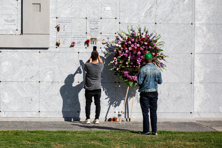 LOS ANGELES, AZ - MARCH 27: People pay their respects at the Hollywood Forever Cemetery, resting place for many of the biggest stars of Hollywood's golden age on Sunday, March 27, 2022 in Los Angeles, AZ. The L.A. City Council unanimous vote to make the Hollywood Forever Cemetery a historic-cultural monument. {({photographer} / Los Angeles Times)