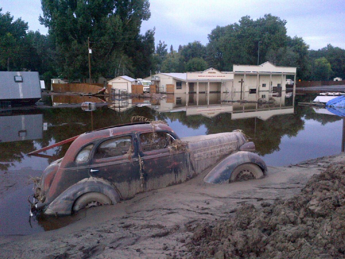 A car swallowed by mud in Loveland, Colo.