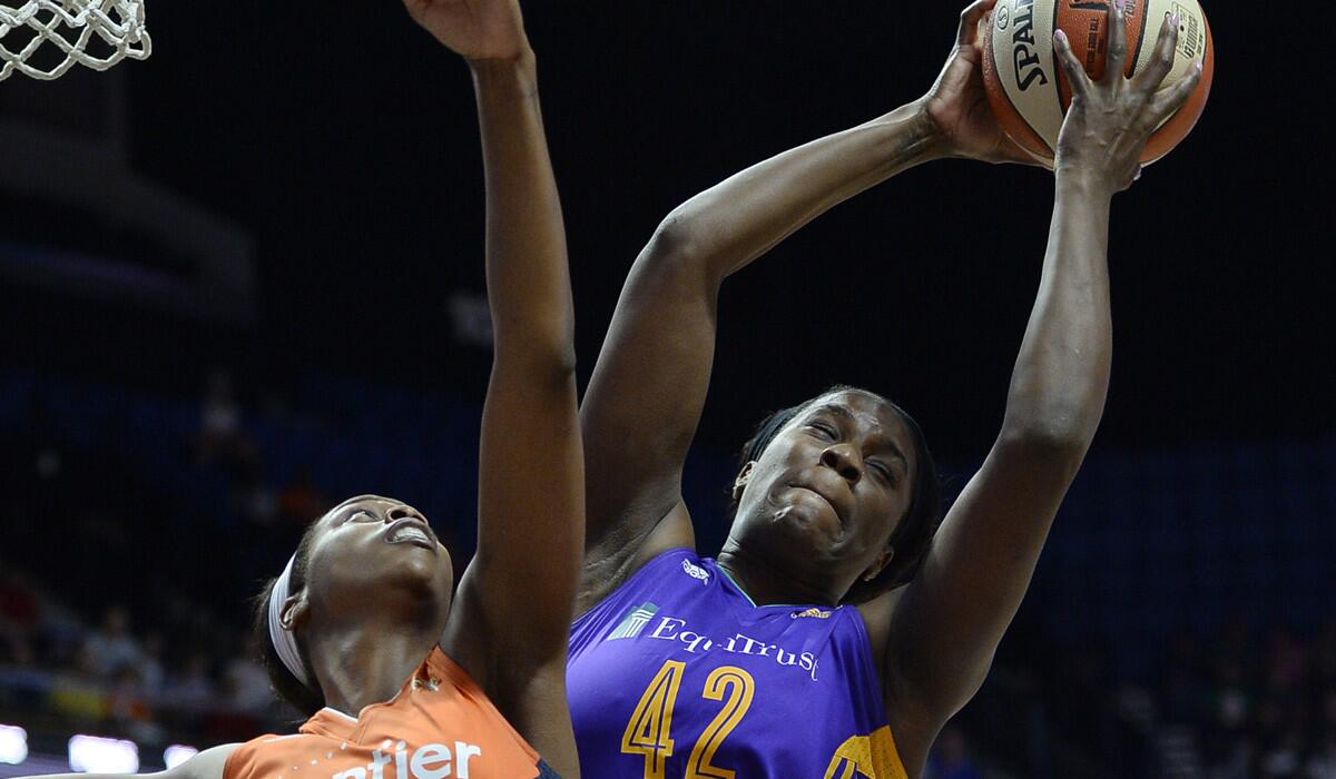 Sparks' Jantel Lavender, right, pulls down a rebound over Connecticut's Camille Little.