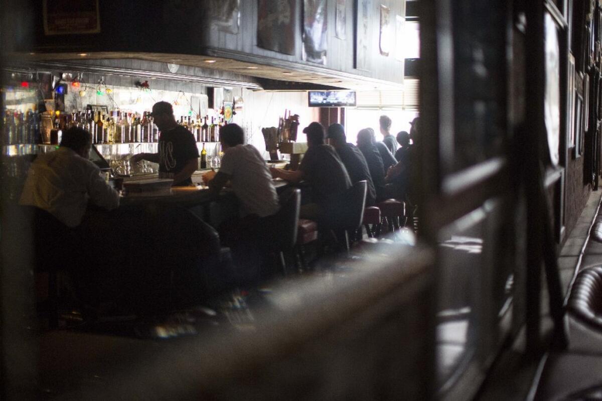 Customers nurse drinks at the Powerhouse bar in Hollywood, which is preparing to close.