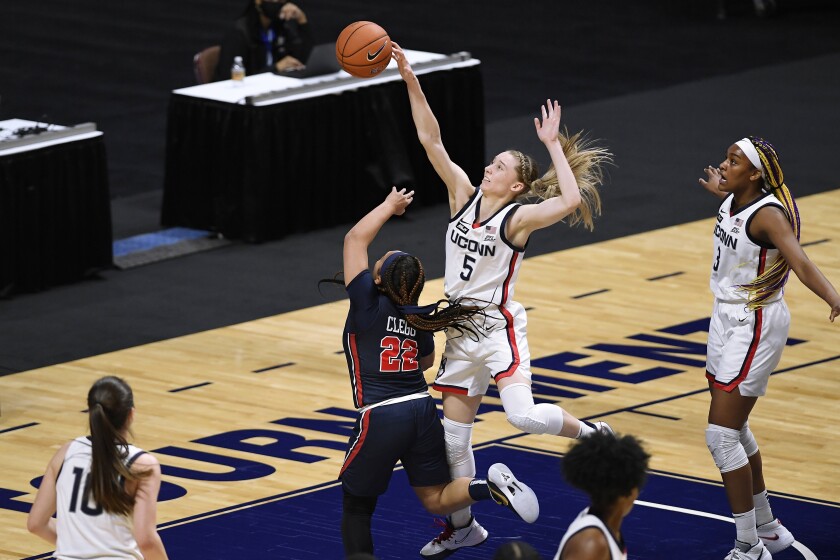 Connecticut's Paige Bueckers blocks a shot by St. John's Camree Clegg (22) during the first half of an NCAA college basketball game in the quarterfinals of the Big East Conference tournament at Mohegan Sun Arena, Saturday, March 6, 2021, in Uncasville, Conn. (AP Photo/Jessica Hill)