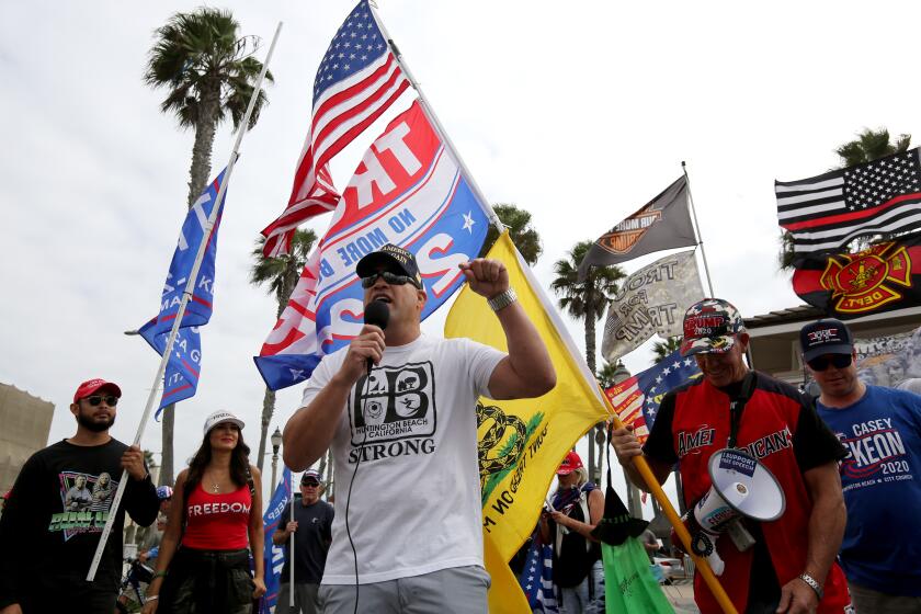 City council candidate Tito Ortiz speaks to the crowd during Trump rally at the pier, in Huntington Beach on Saturday, Oct. 24, 2020. The car rally began in Laguna Niguel, where dozens of cars headed north on Coast Highway, and ended at the iconic pier.