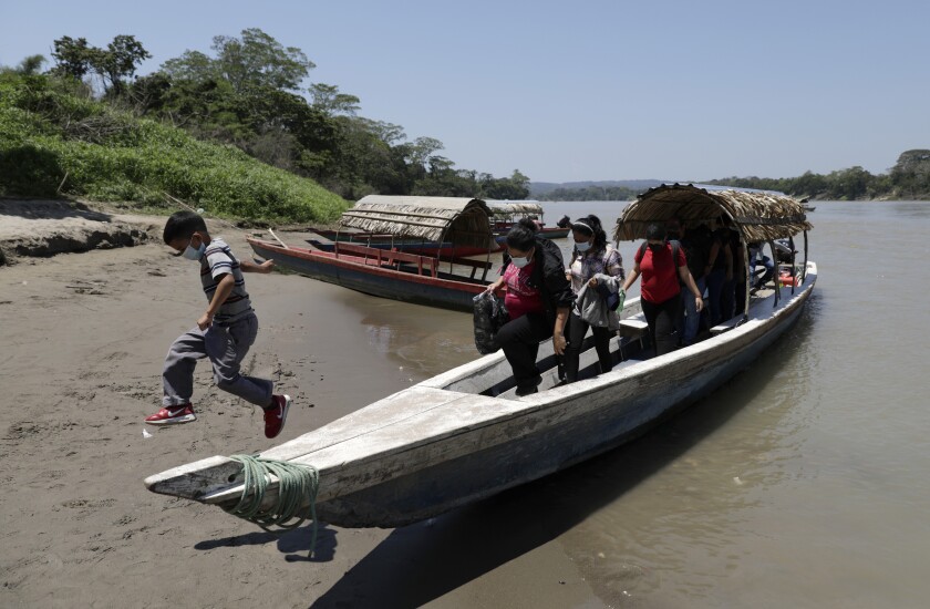 Migrants disembark on the Mexican side of the border after crossing the Usumacinta River from Guatemala, in Frontera Corozal, Chiapas state, Mexico, Wednesday, March 24, 2021. (AP Photo/Eduardo Verdugo)