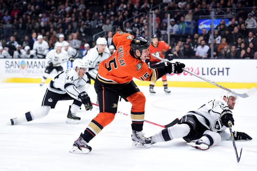 Ducks captain Ryan Getzlaf (15) unleashes a shot past sliding Kings defenseman Alec Martinez for a goal in the first period.