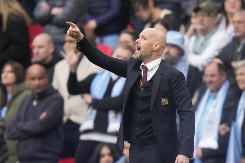 Manchester United's head coach Erik ten Hag shouts to his players from the sideline during the English FA Cup semifinal soccer match between Coventry City and Manchester United at Wembley stadium in London, Sunday, April 21, 2024. (AP Photo/Alastair Grant)